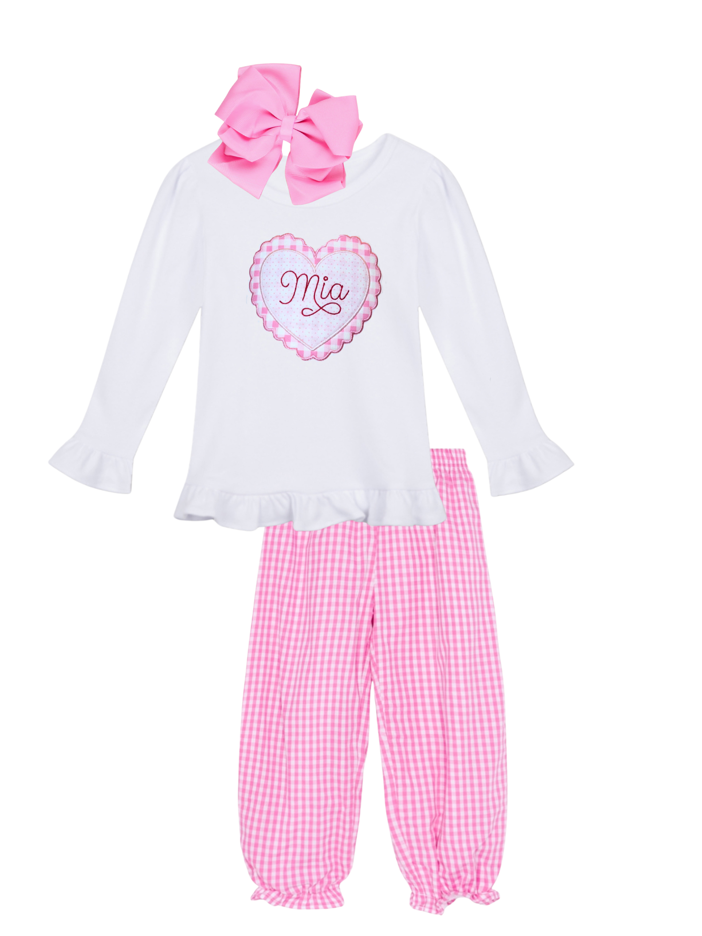 Children's outfit with white top, pink checkered pants, and large pink bow on a white background